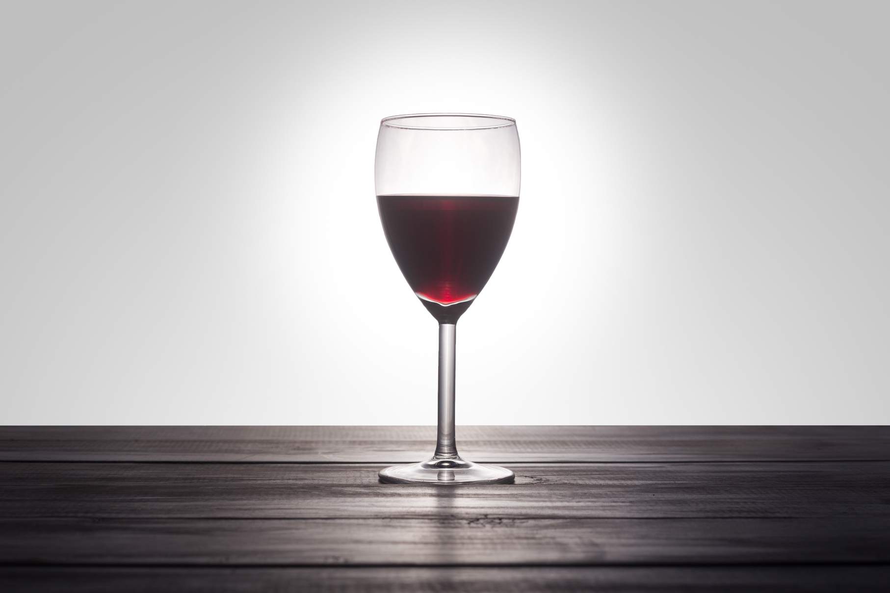 Red wine glass on table