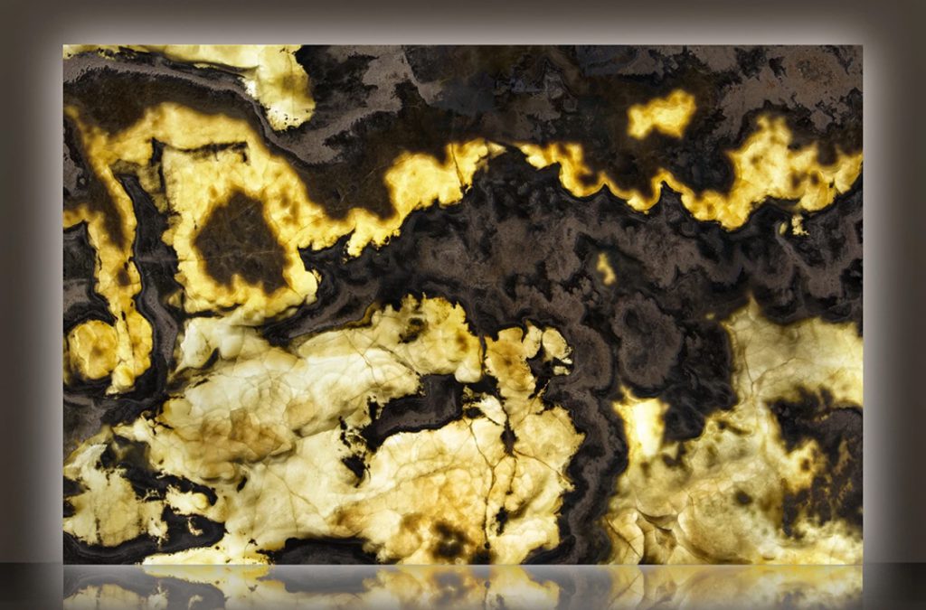 backlit slab of black and gold onyx