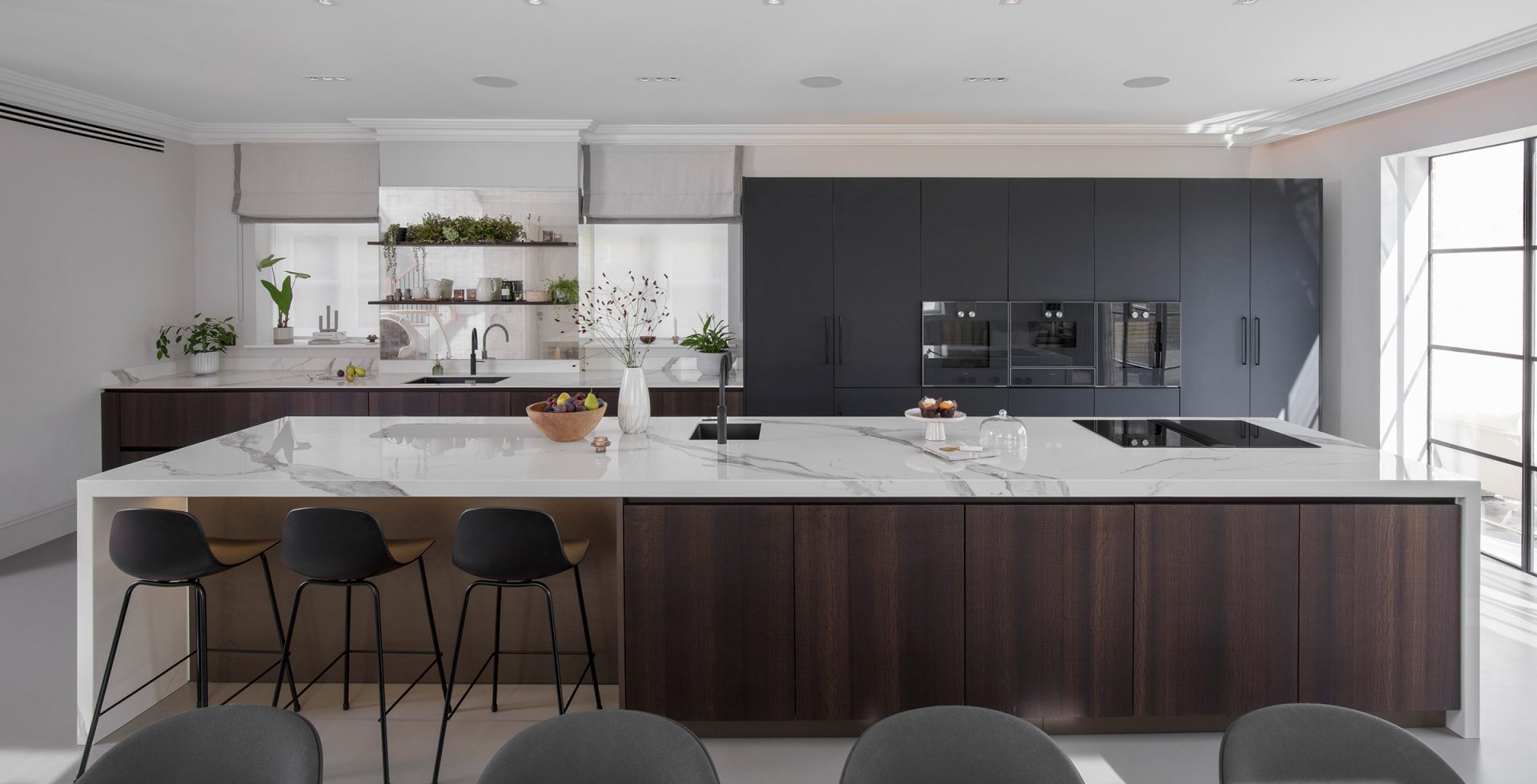 family kitchen with wood island and marble worktops