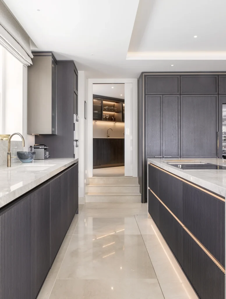 dark wood bespoke kitchen with door to prep kitchen