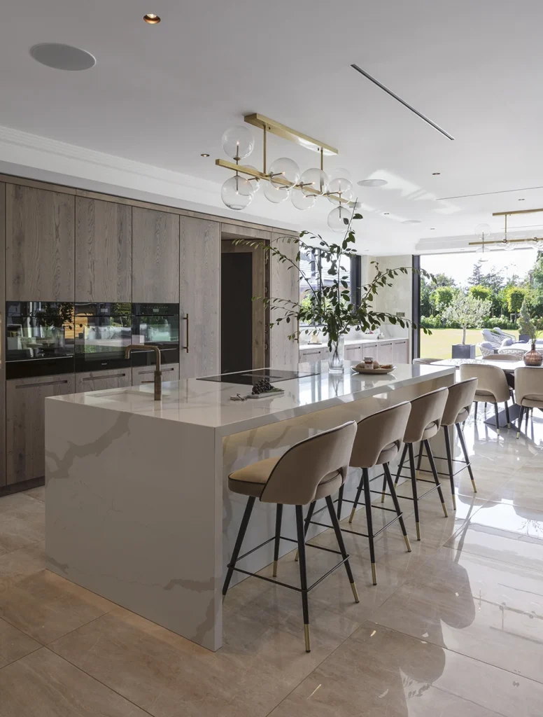 stylish timber kitchen with white marble island with breakfast bar overhang
