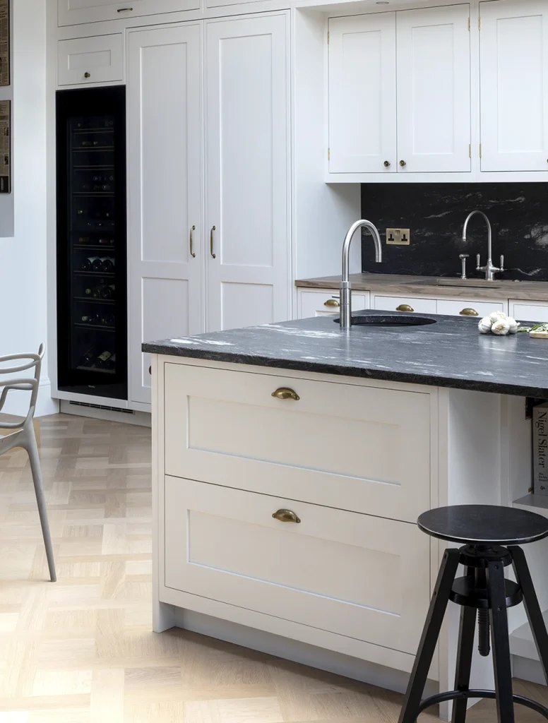 White bespoke shaker kitchen with antique handmade brass cup handles and bar handles