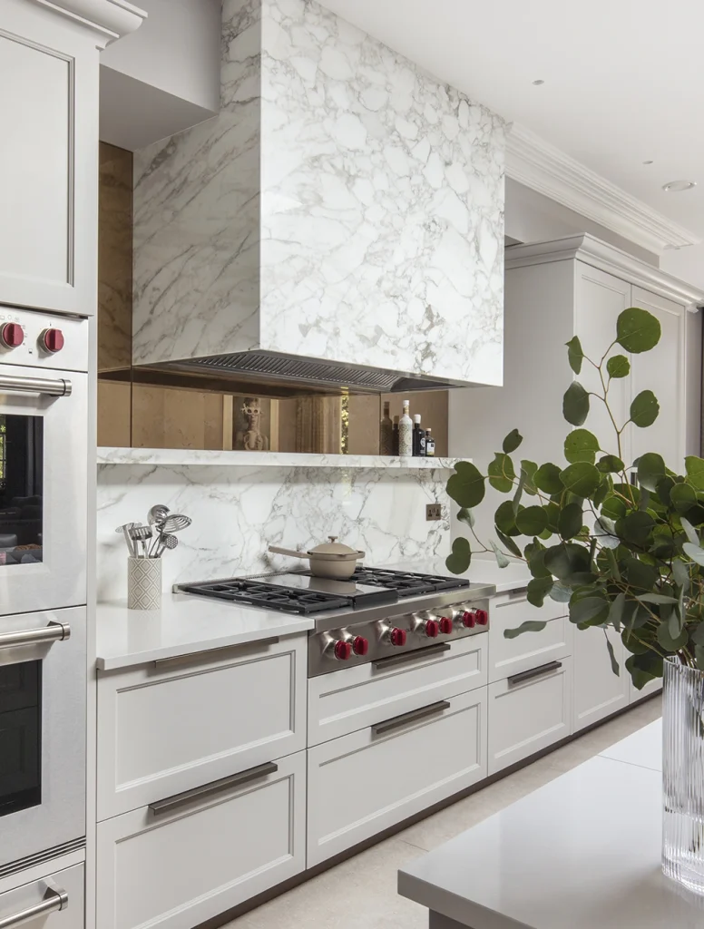 contemporary classic style kitchen with Wolf range cooker and stone-clad marble feature cooker hood