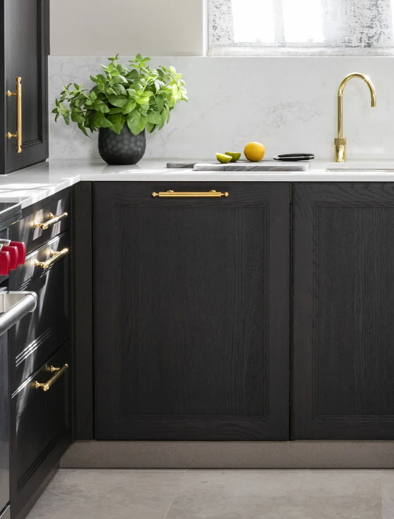 dark timber classic kitchen with stepped beading door detail, marble worktops and polished brass handles and tap